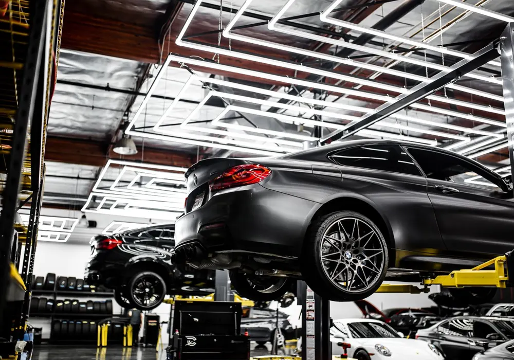BMW on a lift in a modern workshop